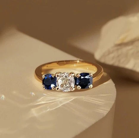 1+1 Offer: Golden Three Stone Cushion Cut White & Blue Sapphire Wedding Band Ring for Women + Round Cut White Sapphire Gold Necklace